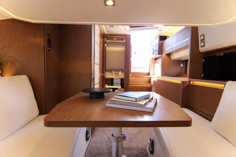 Slide: The Image of Luxurious interior of 2021 Jeanneau Leader 12.5 WA yacht with wooden table and seating. - 61