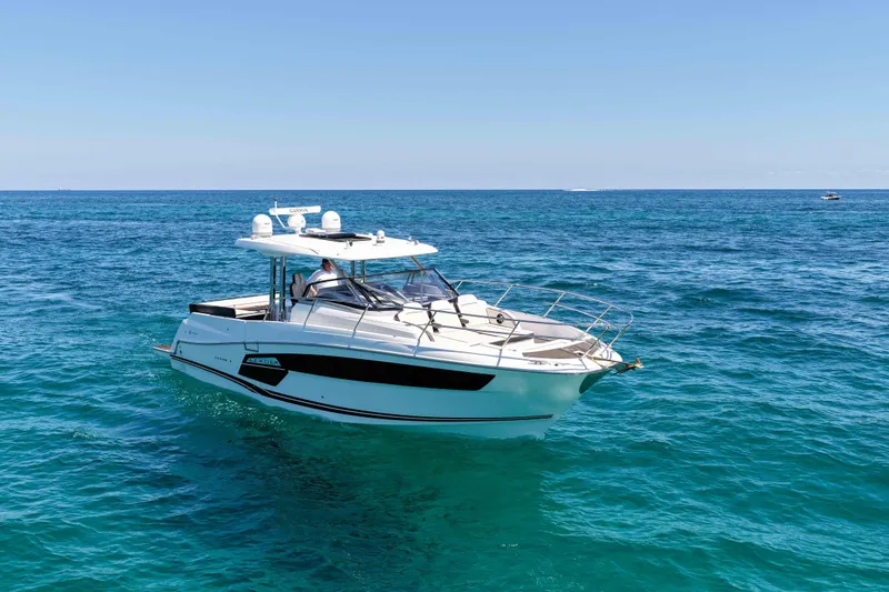 Slide: The Image of 2021 Jeanneau Leader 12.5 WA cruising on clear blue ocean waters. - 7