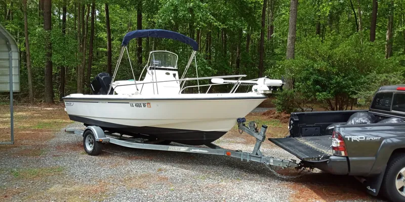 Slide: The Image of 2003 Boston Whaler 190 Nantucket on trailer parked in forest. - 2