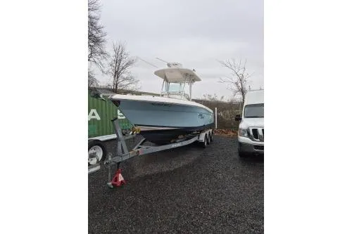 The Image of 2005 Robalo R260 Center Console boat on trailer in outdoor setting. - 1