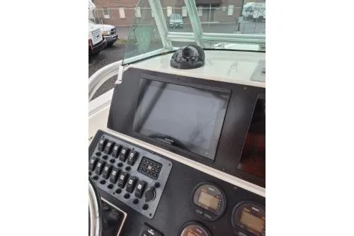Slide: The Image of 2005 Robalo R260 Center Console boat dashboard with navigation controls and display screen. - 10
