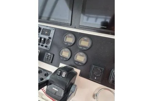 Slide: The Image of Control panel of a 2005 Robalo R260 Center Console boat with gauges and screens. - 11