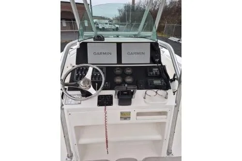 Slide: The Image of 2005 Robalo R260 Center Console boat dashboard with Garmin navigation displays. - 12