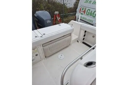 Slide: The Image of 2005 Robalo R260 Center Console boat interior with storage and engine view. - 15