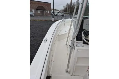Slide: The Image of 2005 Robalo R260 Center Console boat, white deck view, parked outdoors. - 4