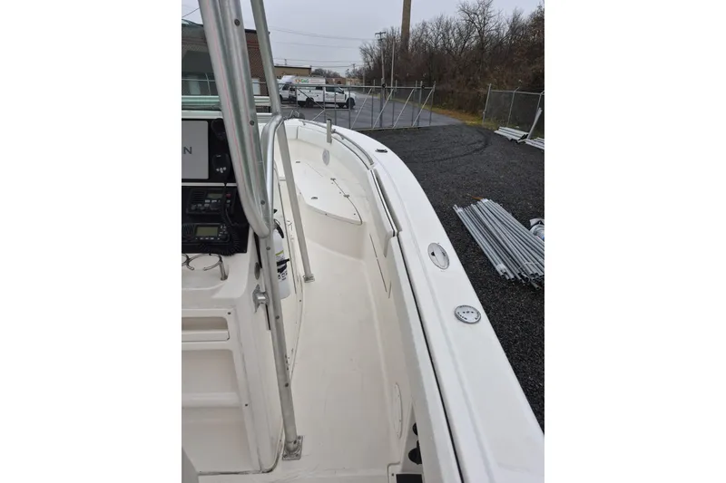 Slide: The Image of 2005 Robalo R260 Center Console boat, white deck, parked outdoors on gravel. - 5