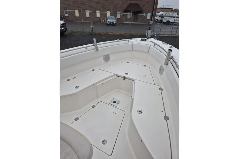 Slide: The Image of 2005 Robalo R260 Center Console boat deck with storage compartments. - 7
