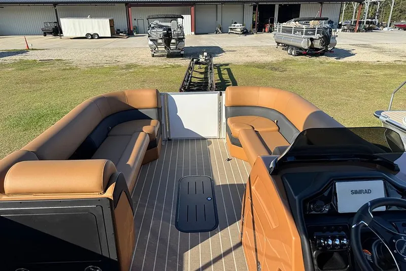 Slide: The Image of 2026 Bentley Pontoons Elite 253 Admiral interior with tan seating and modern dashboard. - 17