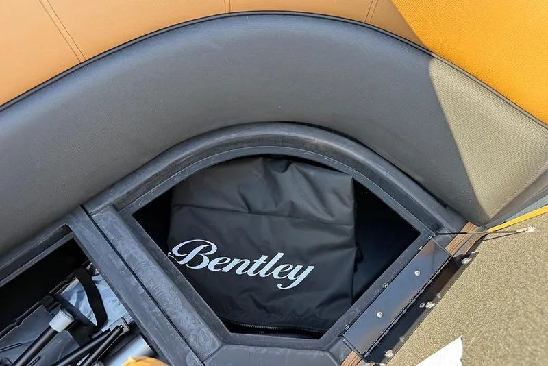 Slide: The Image of 2026 Bentley Pontoons Elite 253 Admiral storage compartment with branded cover. - 25