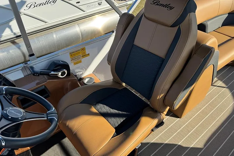 Slide: The Image of 2026 Bentley Pontoons Elite 253 Admiral interior with luxurious seating and steering wheel. - 31