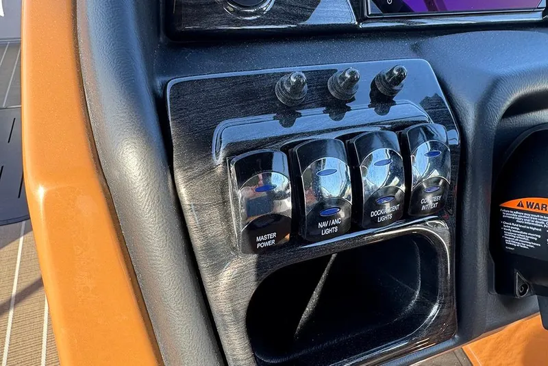 Slide: The Image of Control panel of 2026 Bentley Pontoons Elite 253 Admiral with labeled switches. - 36