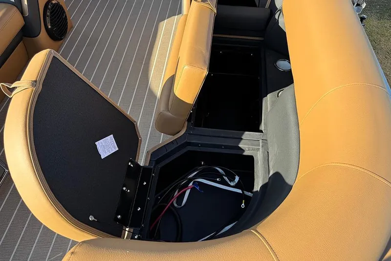 Slide: The Image of 2026 Bentley Pontoons Elite 253 Admiral interior storage compartment with tan seating. - 47
