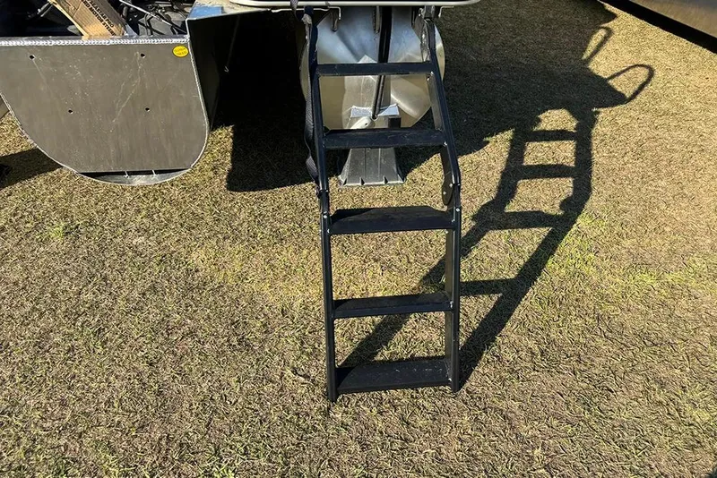 Slide: The Image of Ladder attached to 2026 Bentley Pontoons Elite 253 Admiral on grassy surface. - 5