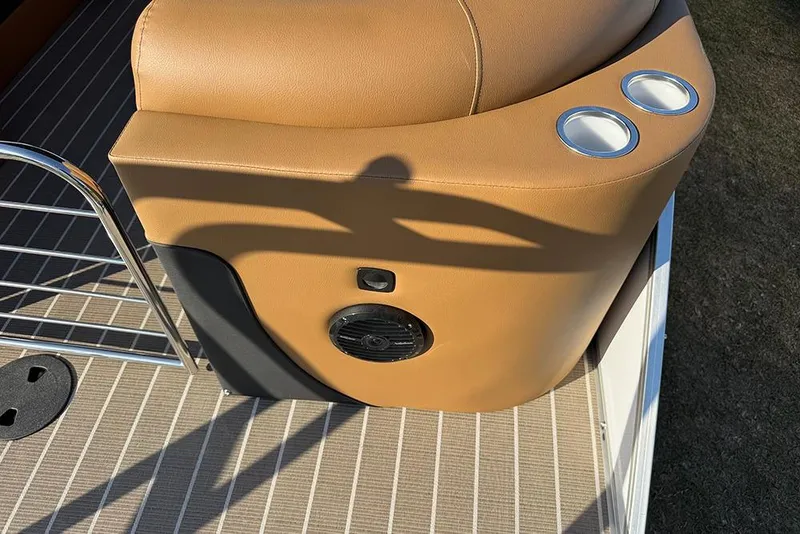 Slide: The Image of 2026 Bentley Pontoons Elite 253 Admiral interior with tan upholstery and cup holders. - 56