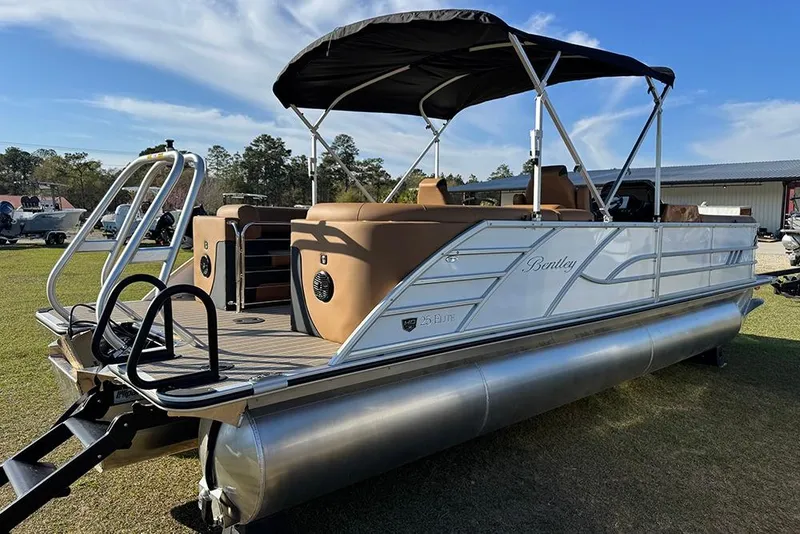 Slide: The Image of 2026 Bentley Pontoons Elite 253 Admiral on grass, featuring sleek design and canopy. - 6
