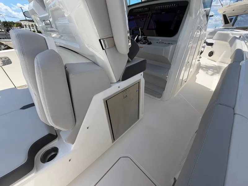 Slide: The Image of The image shows the cockpit of a 2026 Boston Whaler 330 Outrage with modern seating and helm station. - 27