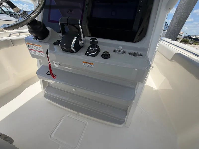 Slide: The Image of The image shows the helm of a Boston Whaler 330 Outrage with modern controls and screens. - 31