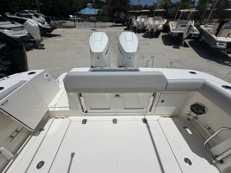 Slide: The Image of The image shows the stern of a Boston Whaler 330 Outrage with two outboard engines. - 18