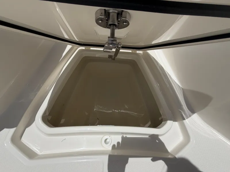 Slide: The Image of An open storage compartment on a boat with a metal latch. - 46