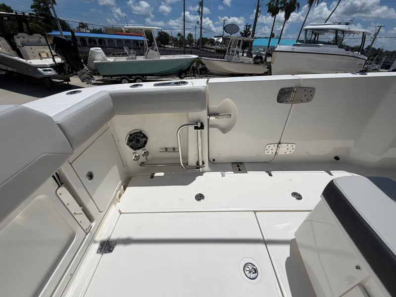 Slide: The Image of The image shows the cockpit of a 2026 Boston Whaler 330 Outrage with white upholstery and stainless steel fittings. - 21