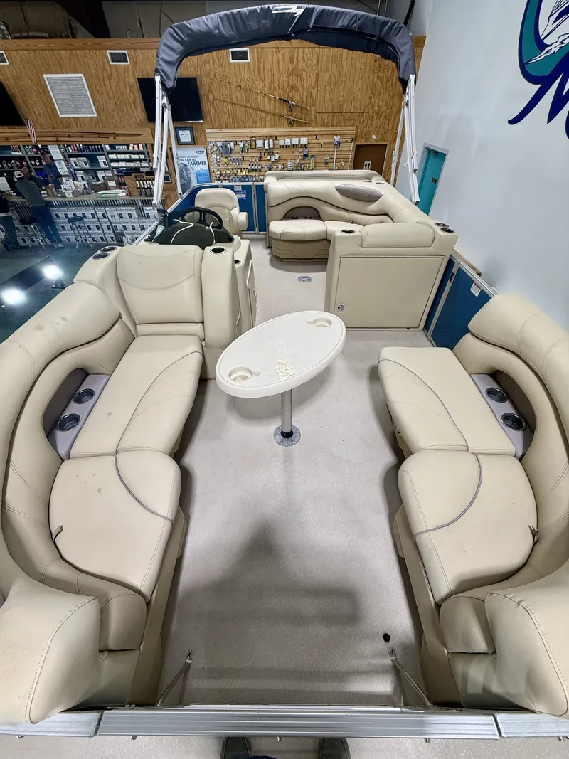 Slide: The Image of Interior view of a 2017 Sylvan 8520 pontoon boat with beige seating. - 10