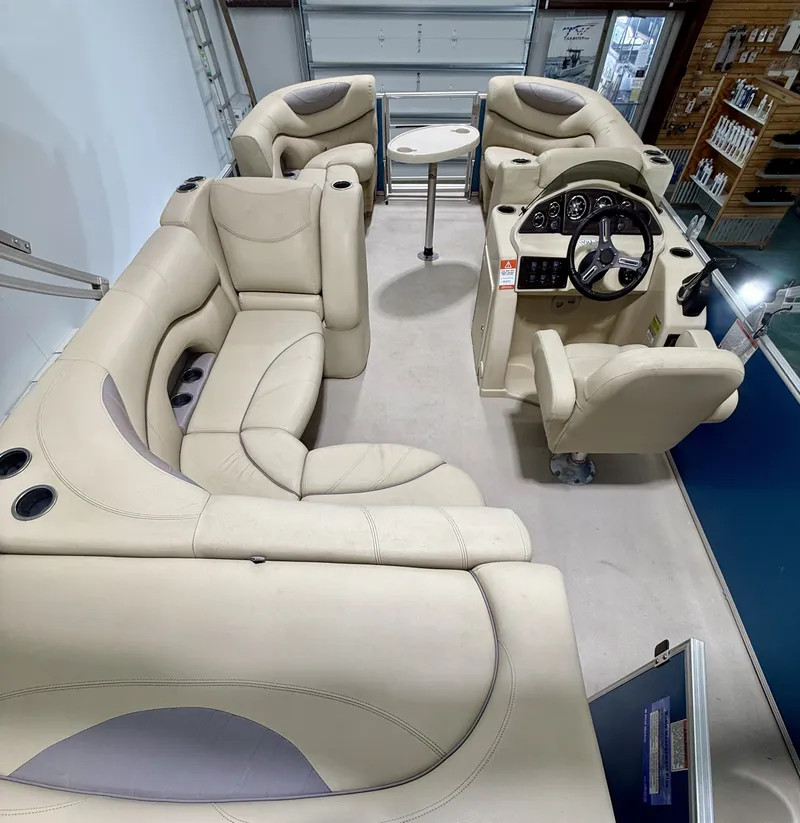 Slide: The Image of Interior of a 2017 Sylvan 8520 pontoon boat with beige seating. - 12