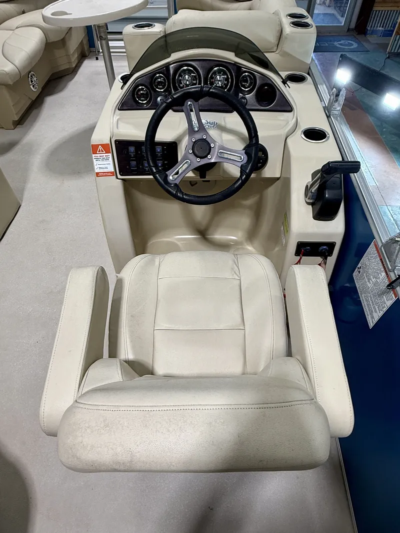 Slide: The Image of 2017 Sylvan 8520 boat helm with steering wheel and seat. - 14