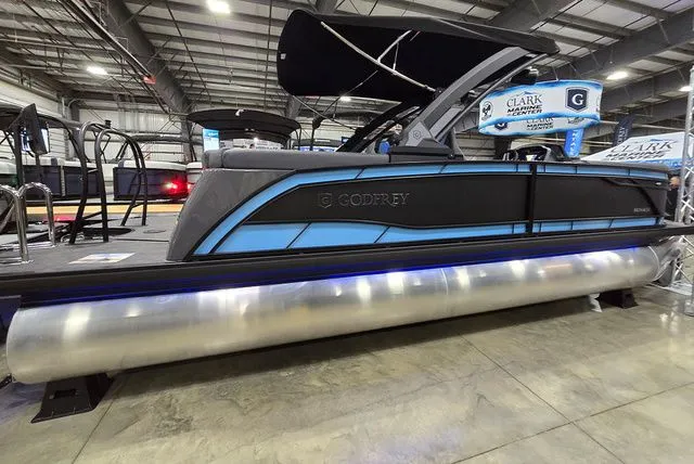 The Image of Godfrey Monaco 235 ULC iMPACT 2026 pontoon boat in a showroom. - 1