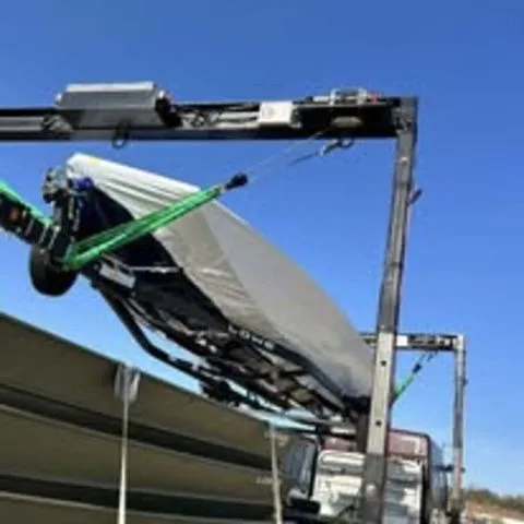 Slide: The Image of Lowe Stinger 195C 2025 boat being loaded with a crane. - 6