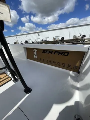 Slide: The Image of 2023 Sea Pro 248 Bay Series boat deck under cloudy sky. - 19