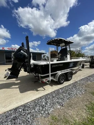Slide: The Image of 2023 Sea Pro 248 Bay Series boat on trailer under cloudy sky. - 3