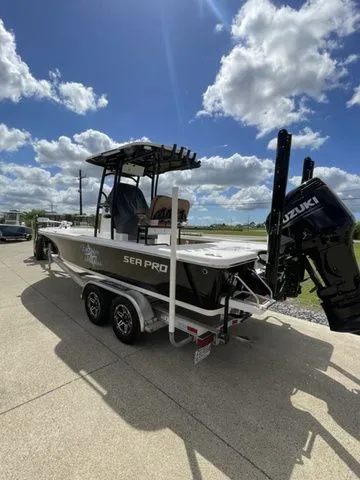 Slide: The Image of 2023 Sea Pro 248 Bay Series boat on trailer, sunny day. - 5