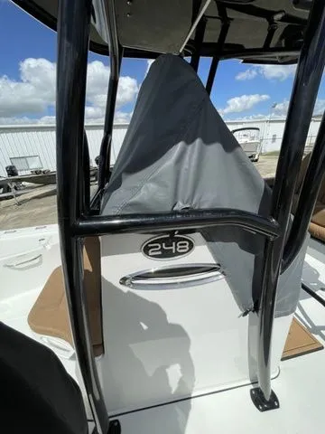 Slide: The Image of 2023 Sea Pro 248 Bay Series boat with cover and blue sky. - 8
