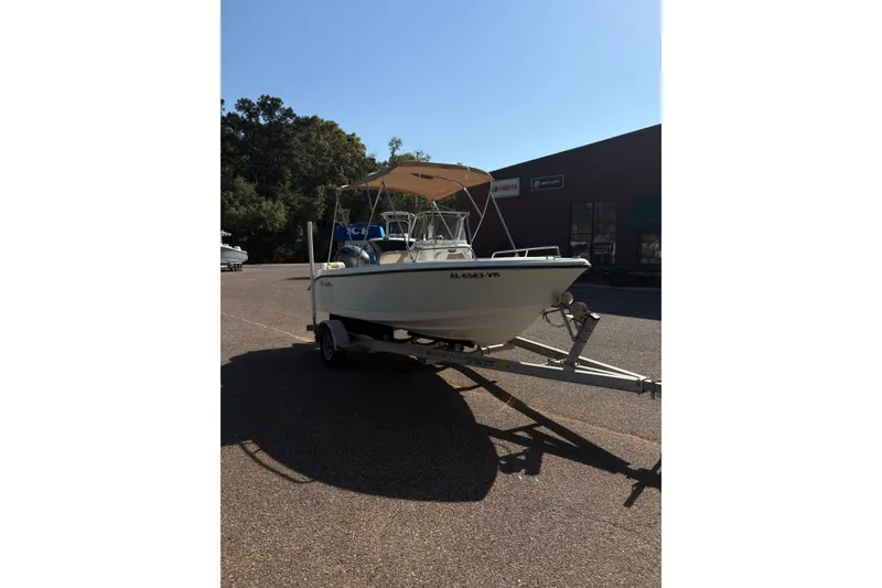 Slide: The Image of 2021 Edgewater 170CC boat on trailer in parking lot, sunny day. - 2