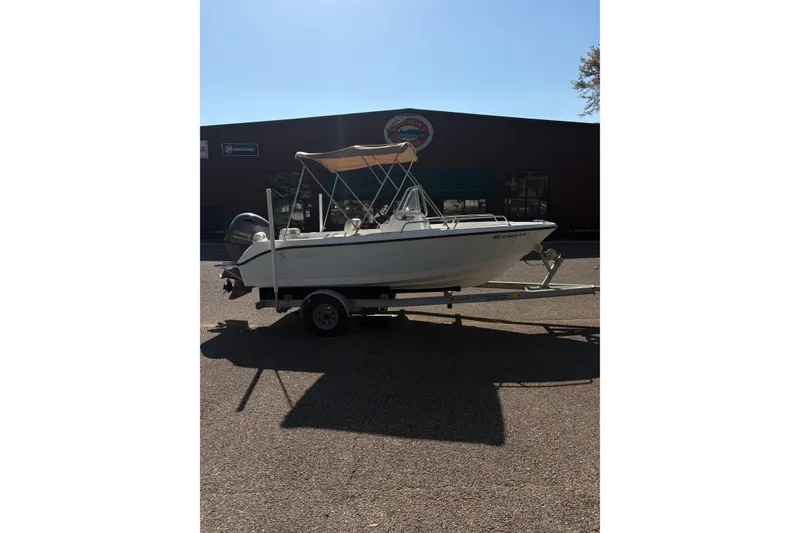 Slide: The Image of 2021 Edgewater 170CC boat on trailer, parked outdoors with a canopy. - 3
