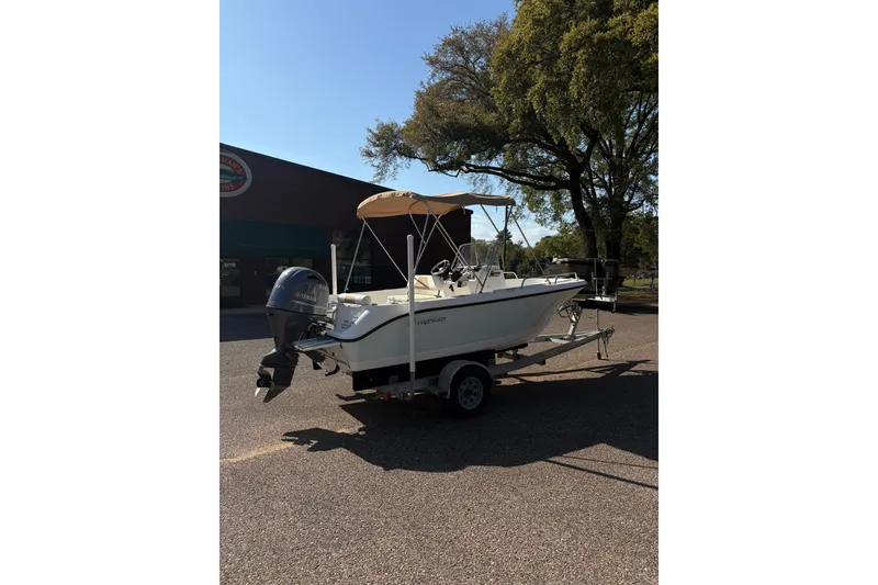Slide: The Image of 2021 Edgewater 170CC boat on trailer, parked outdoors under clear sky. - 4