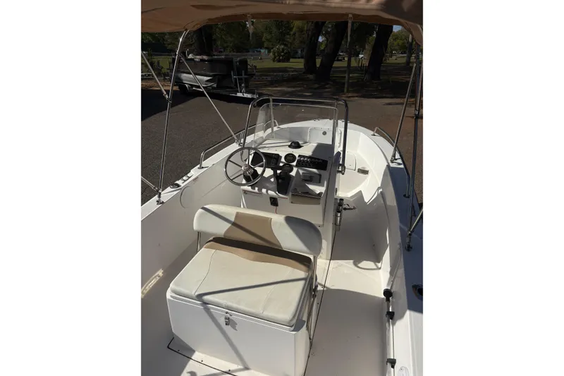 Slide: The Image of 2021 Edgewater 170CC boat interior with steering wheel and seating. - 5