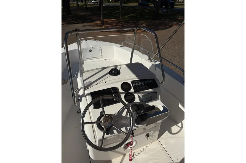 Slide: The Image of 2021 Edgewater 170CC boat console with steering wheel and controls. - 6