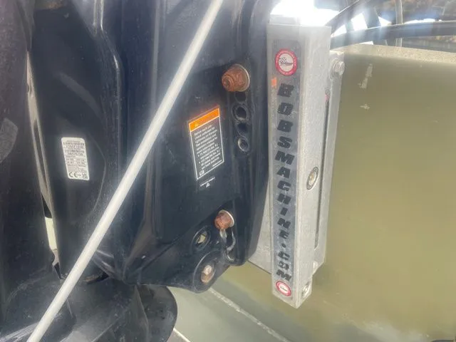 Slide: The Image of Close-up of a boat outboard motor with Bob's Machine accessory. - 6