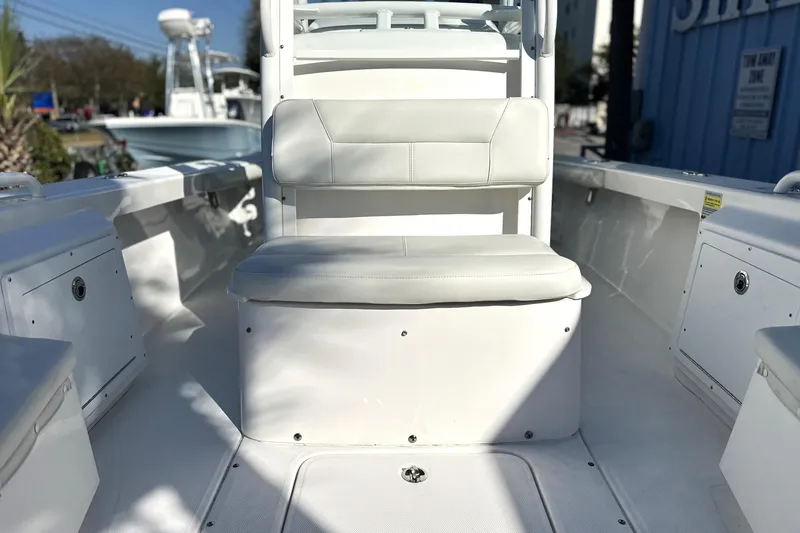 Slide: The Image of 2020 Everglades 243 Center Console boat interior with white seating and storage compartments. - 14
