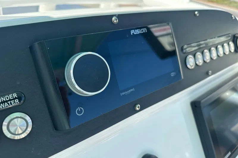 Slide: The Image of Control panel of 2020 Everglades 243 Center Console boat with Fusion audio system. - 17