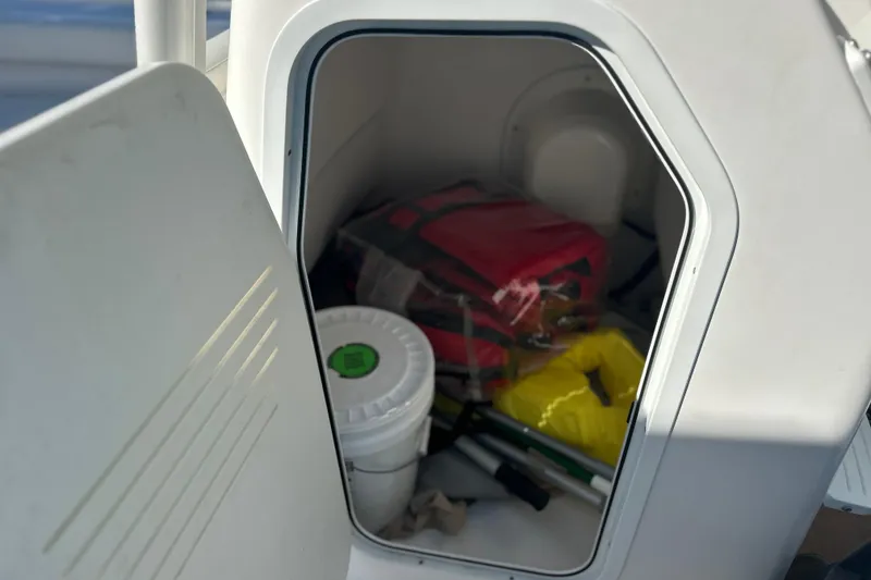 Slide: The Image of Storage compartment on a 2020 Everglades 243 Center Console boat with safety gear. - 18
