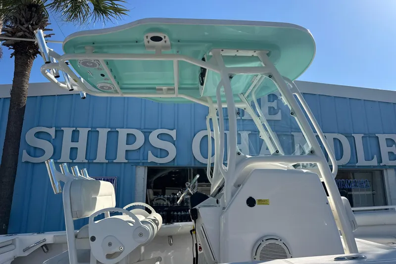 Slide: The Image of 2020 Everglades 243 Center Console boat at a nautical store, blue sky background. - 2
