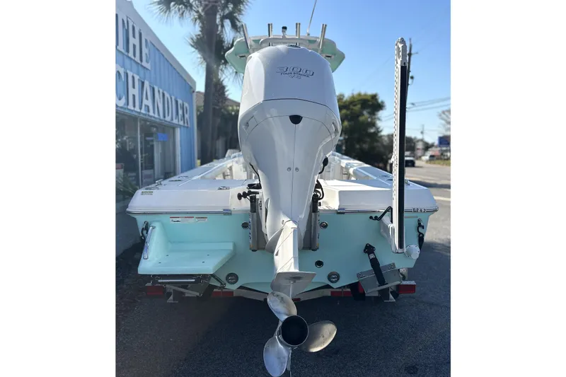 Slide: The Image of 2020 Everglades 243 Center Console boat with powerful outboard motor, parked outdoors. - 3