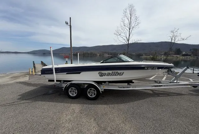 The Image of 2000 Malibu Sunsetter LXi boat on trailer by lakeside. - 1