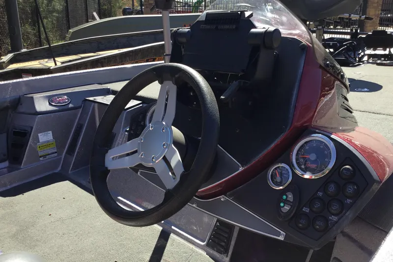 Slide: The Image of 2015 Ranger Z118 Comanche boat dashboard with steering wheel and control panel. - 2