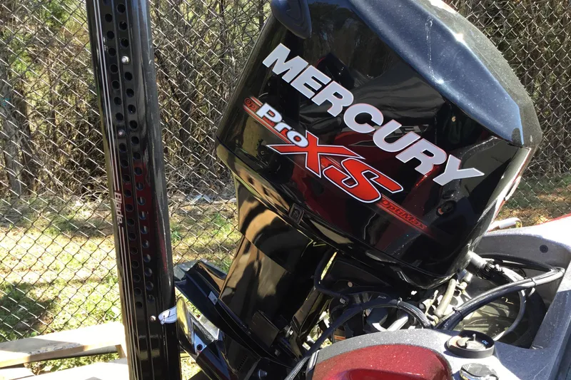 Slide: The Image of 2015 Ranger Z118 Comanche with Mercury Pro XS engine, parked near a chain-link fence. - 3