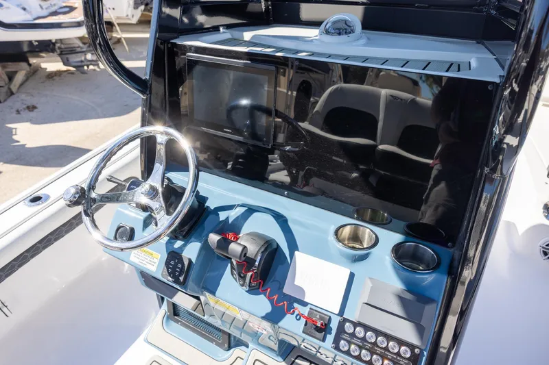 Slide: The Image of Helm of 2025 Tidewater 2500 Carolina Bay boat with steering wheel and controls. - 10