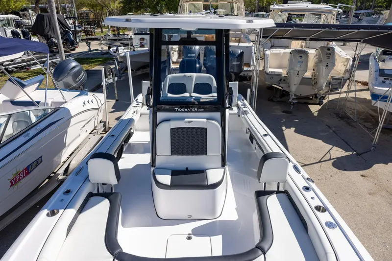 Slide: The Image of 2025 Tidewater 2500 Carolina Bay boat, sleek design, docked among other vessels. - 17