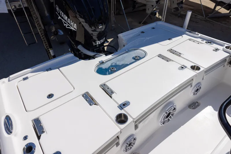 Slide: The Image of 2025 Tidewater 2500 Carolina Bay boat deck with Yamaha 300 engine, featuring storage compartments. - 19